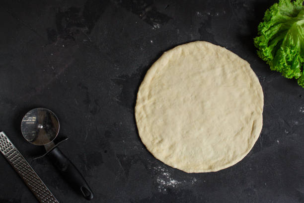 istock pizza, dough, ingredients, tortilla (cooking process). Top view with copy space 1073663980