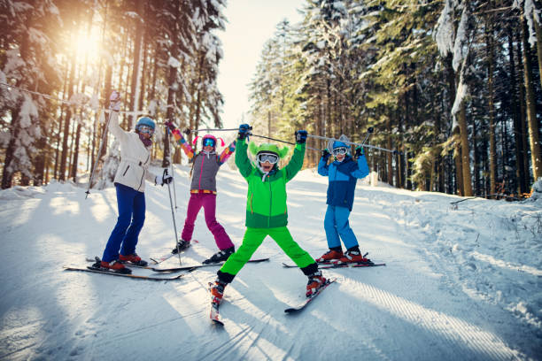 family having fun skiing together on winter day - skiing snow ski slope sunlight imagens e fotografias de stock