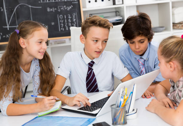 istock children near laptop talking about mathematics 1073671684