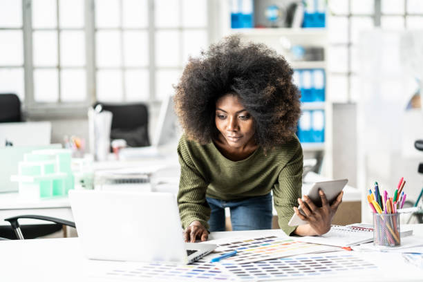 istock Afro woman on her workplace 1073673038