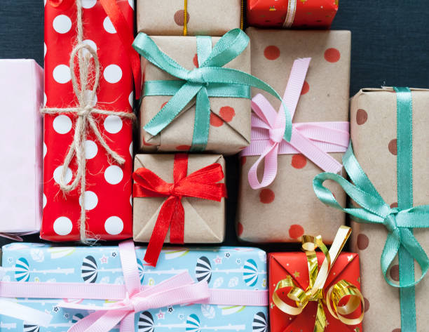 istock Different christmas gifts on a black background 1073674906