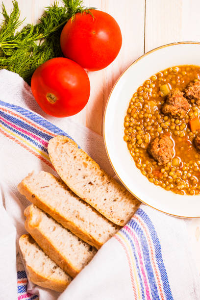 istock Lentil soup with fricandel, tomatoes and bread 1073675506