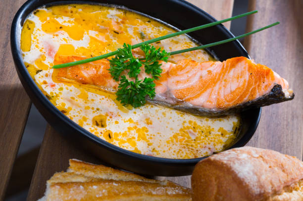 istock Creamy salmon soup with baguette 1073676650
