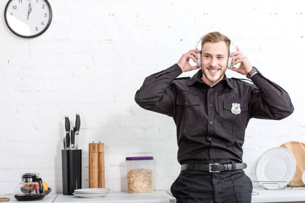 istock Handsome policeman listening to music at kitchen 1073686276