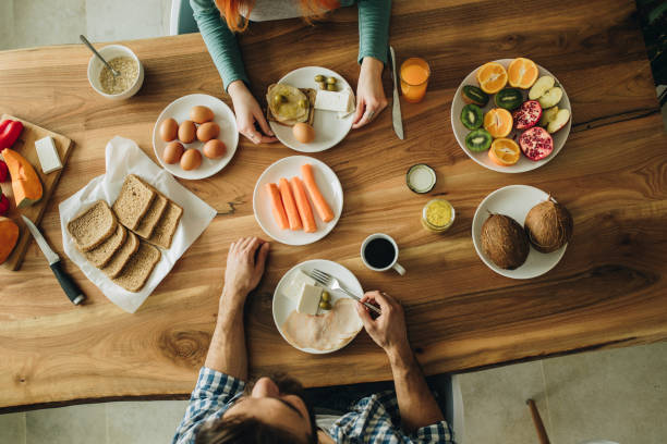istock Above view of people having breakfast at dining table. 1073693034