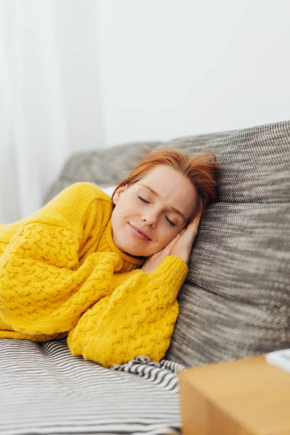 istock Attractive redhead woman taking a nap 1073693150