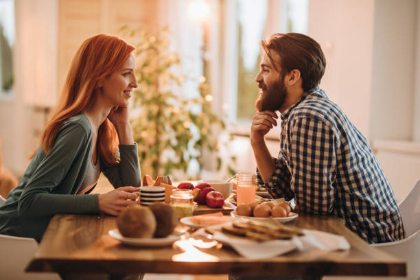 istock Young couple enjoying in their meal while talking to each other. 1073697488