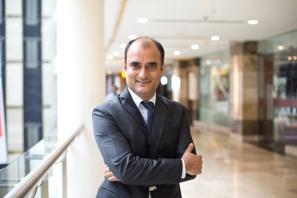 istock Businessman with arms crossed at office corridor 1073697804