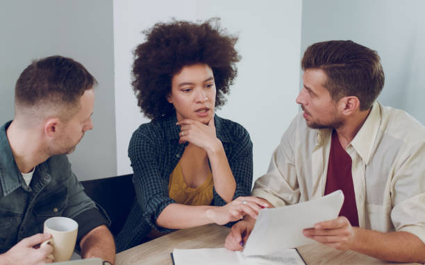 istock Multi-ethnic business people brainstorming in office together 1073701790