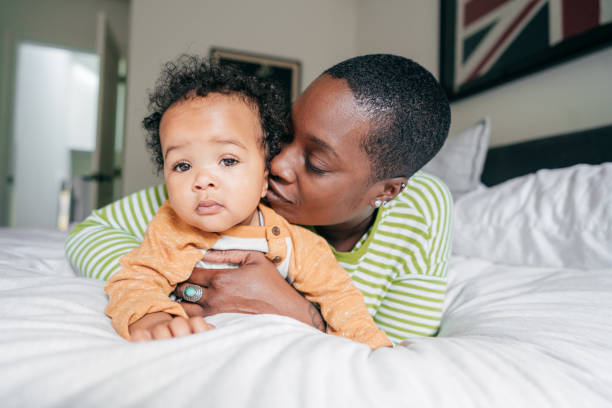 istock Mom kissing her baby boy 1073702368