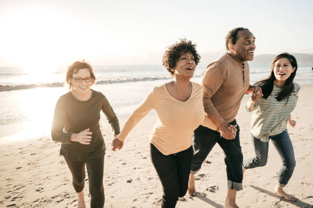 istock Senior friends running together on the beach 1073702534