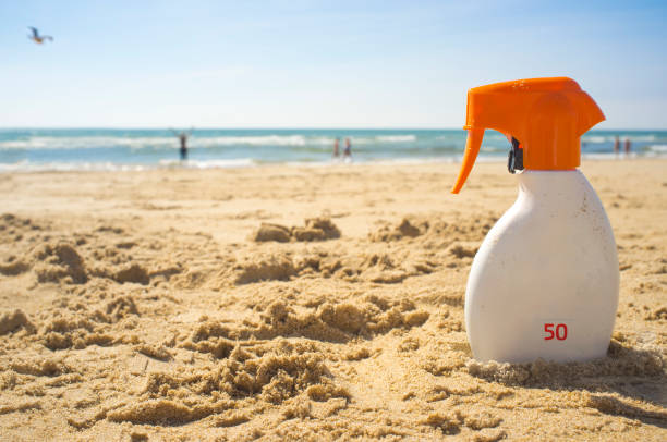 istock Sunblock cream with Sun Protection Factor or SPF 50 on beach sand 1073703836
