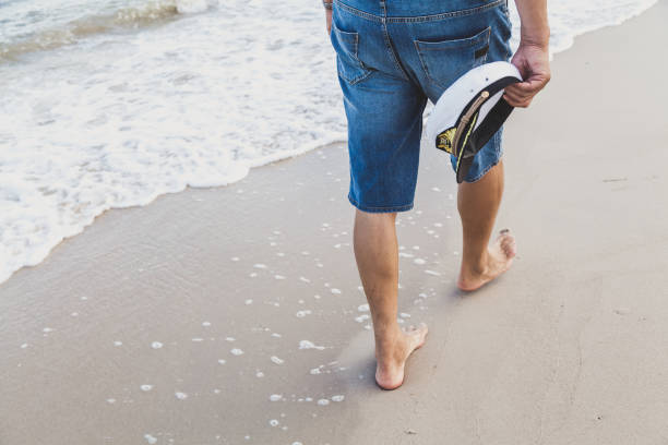 istock Man walks on the sea beach 1073705550