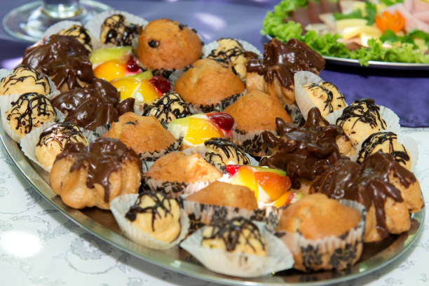 istock Close up of small sweet canapes arranged on a mirror plate over light background - selective focus 1073708432