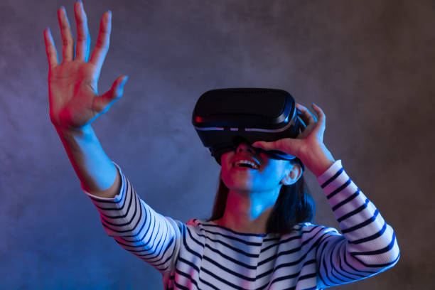 istock Attractive asian girl with VR goggles on head 1073712928
