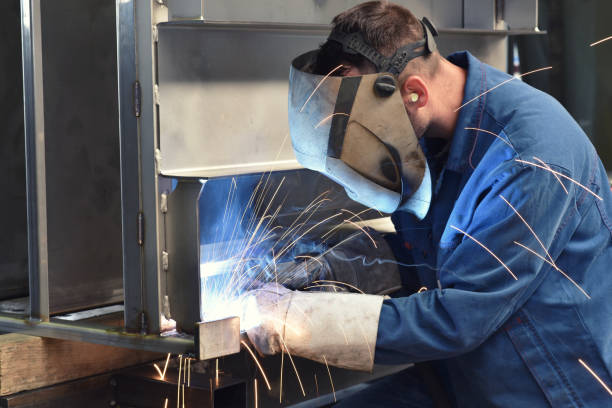 istock welder works in metal construction - construction and processing of steel components 1073715360
