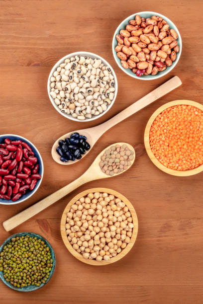 istock Various types of pulses, shot from above on a dark rustic wooden background with copy space. Red kidney, pinto, and black beans, lentils, chickpeas, soybeans, black-eyed peas 1073715840
