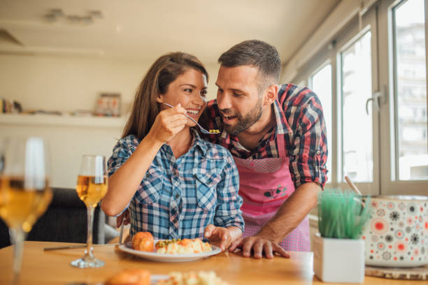 istock Woman feeding her boyfriend 1073716082