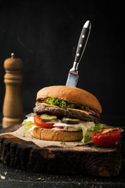 istock Delicious beef burger with knife and spices 1073719628