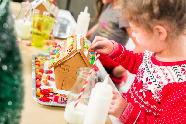 istock Kids decorating small gingerbread houses 1073721354
