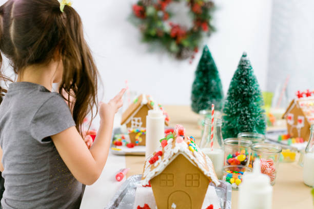 istock Kids decorating small gingerbread houses 1073721372