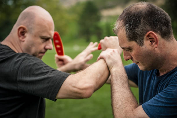 istock Knife vs knife. Kapap instructor demonstrates fighting and disarming technique 1073725494