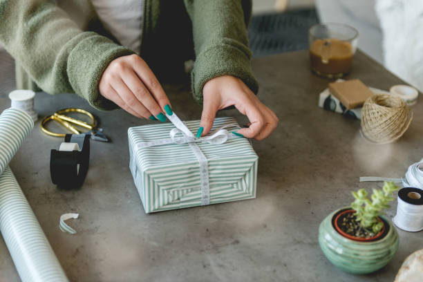 istock Tying a bow on Christmas presents 1073725662