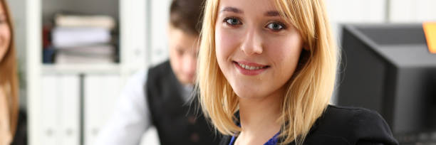 istock Beautiful smiling cheerful girl at workplace 1073726142