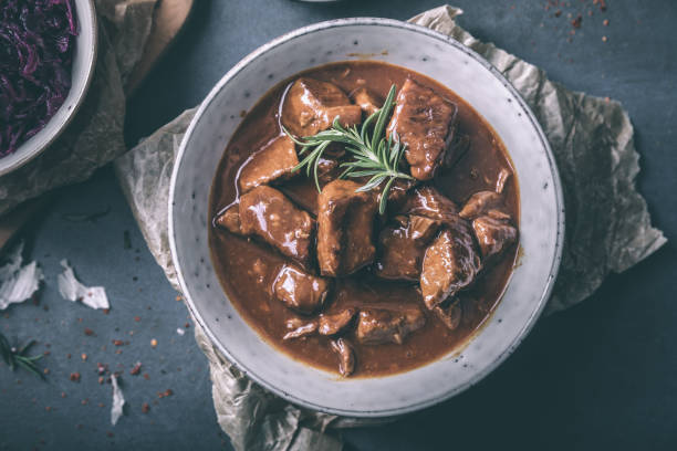 Delicious goulash with red cabbage chili and rosemary Delicious goulash with red cabbage chili and rosemary beef stew stock pictures, royalty-free photos & images