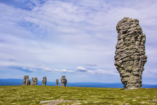Magnificent view of the mountain stone idols. Northern Ural, Russia Plateau Manpupuner. Postcard travel memories.