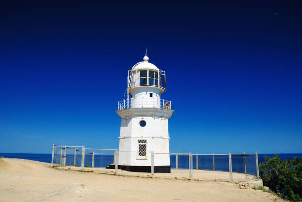 istock Lighthouse on the edge of a mountain 1073730368