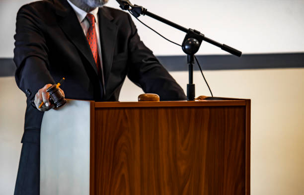 istock Auctioneer with his gavel. selling paintings 1073737364