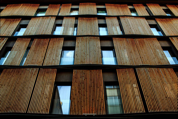 istock A brown modern building with vertical designed wood / lots of windows reflecting 1073739196