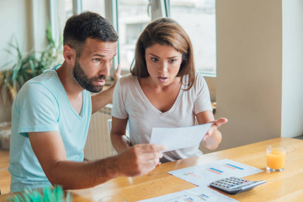 istock Displeased couple looking at financial bills 1073740010
