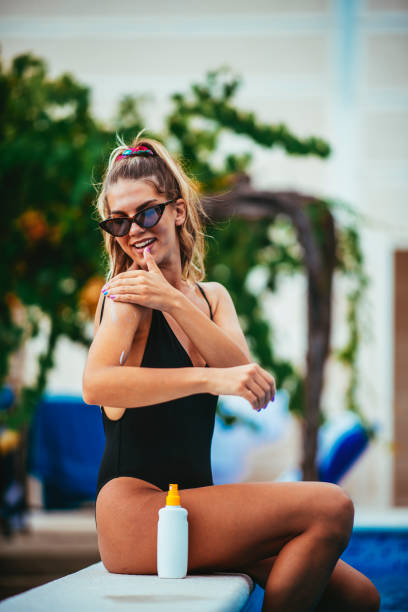 istock Smiling woman holding suntain lotion 1073743944