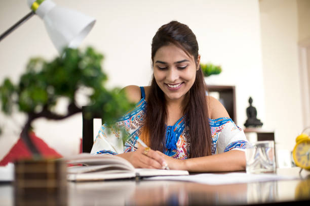 istock Woman reading book at home 1073744486