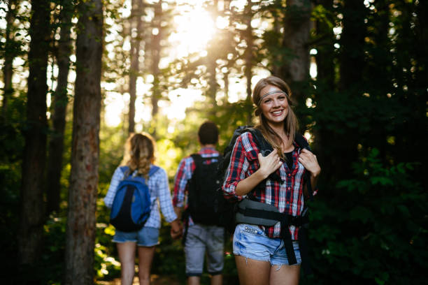 istock Group of backpacking hikers going for forest trekking 1073746686