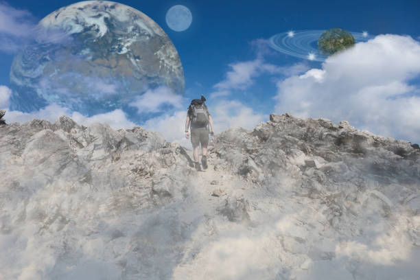 istock man walking in clouds upwards straight to sky with planets 1073750322