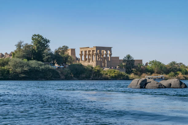 Philae temple and island Philae temple and island in the reservoir of the Aswan Low Dam, downstream of the Aswan Dam and Lake Nasser, Egypt. Philae was originally located near the expansive First Cataract of the Nile in Upper Egypt and was the site of an Egyptian temple complex temple of philae stock pictures, royalty-free photos & images
