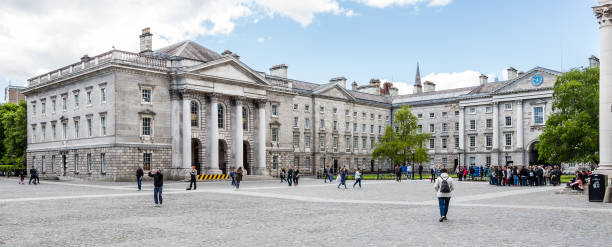 Examination House in Parliament Square at Trinity College in Dublin, Ireland DUBLIN, LEINSTER, IRELAND - MAY 13, 2018: Examination House in Parliament Square at Trinity College with students and visitors walking between buildings like the Book of Kells, or the Chapel. trinity college library stock pictures, royalty-free photos & images