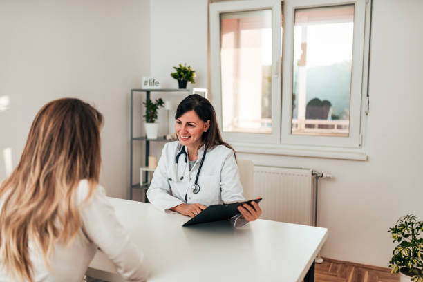 istock Doctor at hospital office having conversation with a patient. 1073757160
