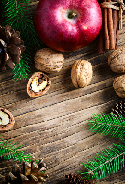 istock Christmas holiday background with fir branches, pine cones and nuts. 1073757198