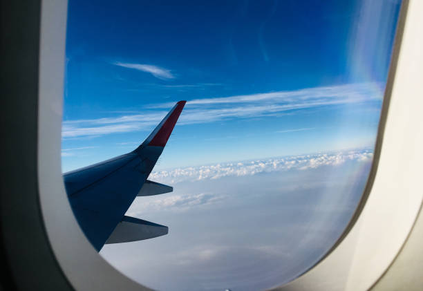 istock Blue Sky view from Plane Window taken from Airplane 1073767782