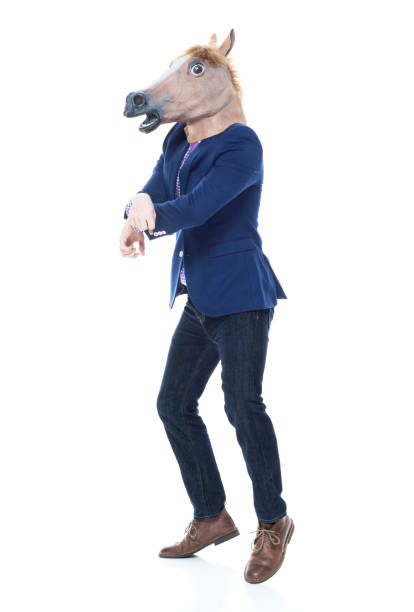 istock Businessman with horse mask is dancing 1073769286