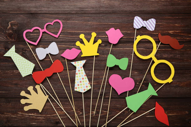 istock Paper booth props for party on brown wooden table 1073770720