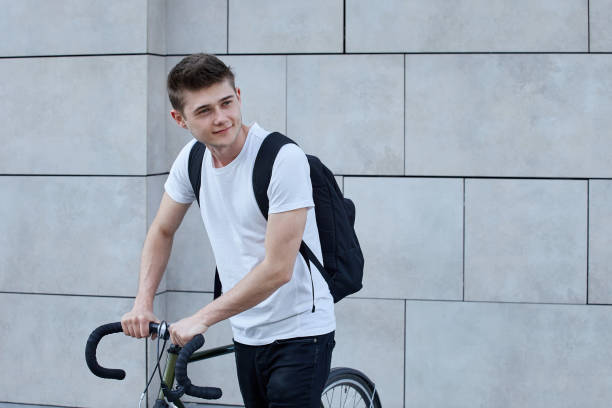 istock Handsome hipster man posing with bicycle in the city. 1073774164