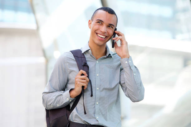 istock young businessman talking on mobile phone and smiling 1073775056