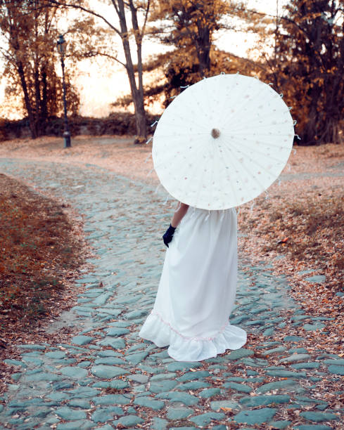 istock Woman with sunshade 1073780542