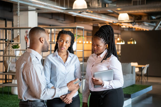 istock Three business people in office having serious discussion 1073787598