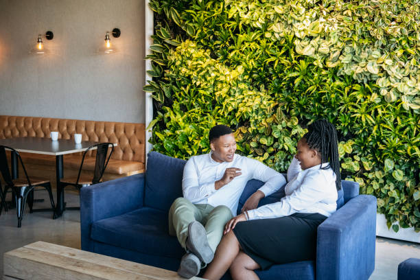 istock Cheerful business colleagues on sofa chatting 1073787758